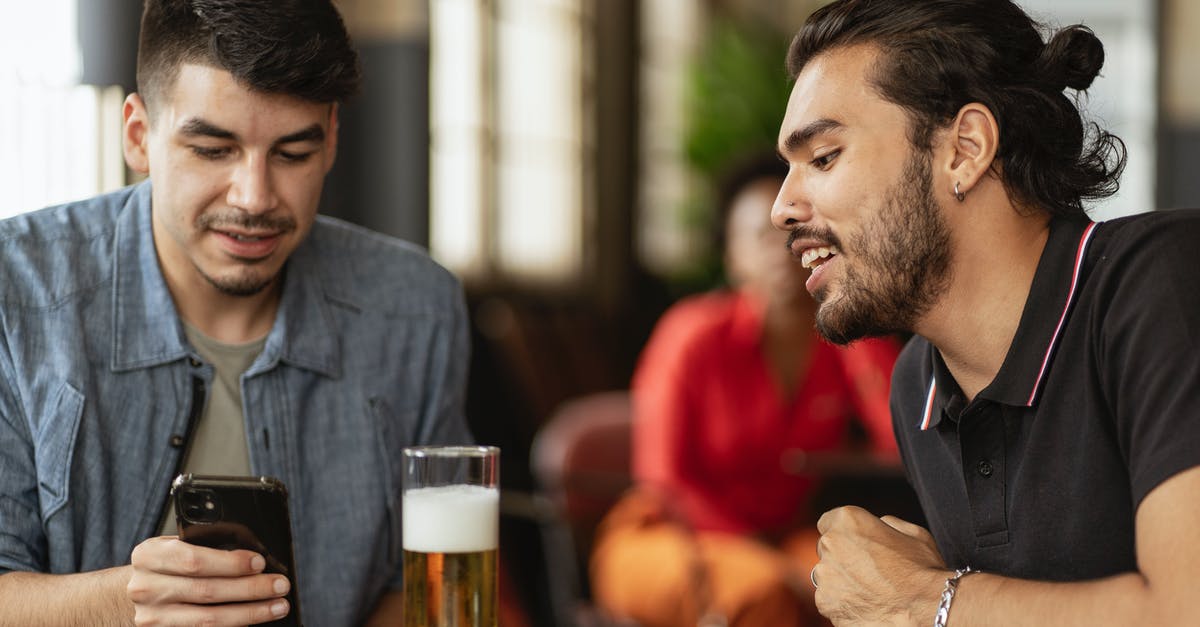 Beer Battered Onion Rings -- what makes them look shiny? - Man in Black T-Shirt Looking at the Phone of Man in Blue Shirt Beer Battered Onion Rings -- what makes them look shiny? - Man in Black T-Shirt Looking at the Phone of Man in Blue Shirt