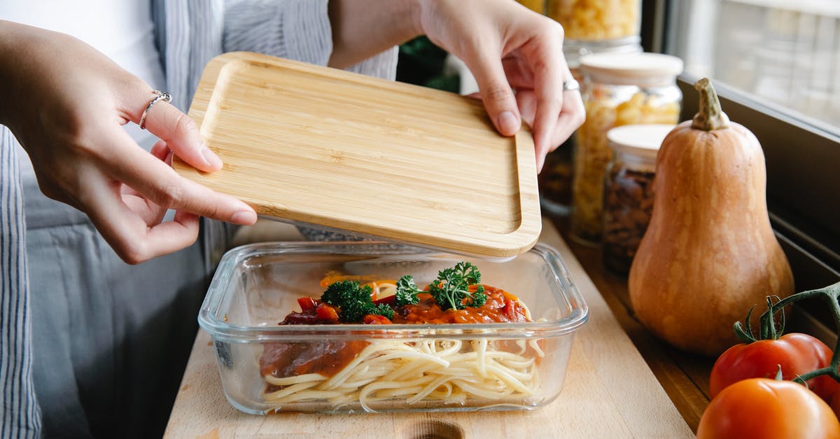 Benefit to covering pasta while cooking? - Unrecognizable woman preparing delicious homemade pasta with tomato sauce in kitchen Benefit to covering pasta while cooking? - Unrecognizable woman preparing delicious homemade pasta with tomato sauce in kitchen