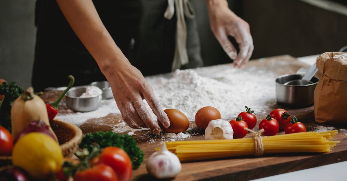 Benefits for different fats for flour tortillas? - Cook preparing food dish standing at table with different ingredients Benefits for different fats for flour tortillas? - Cook preparing food dish standing at table with different ingredients