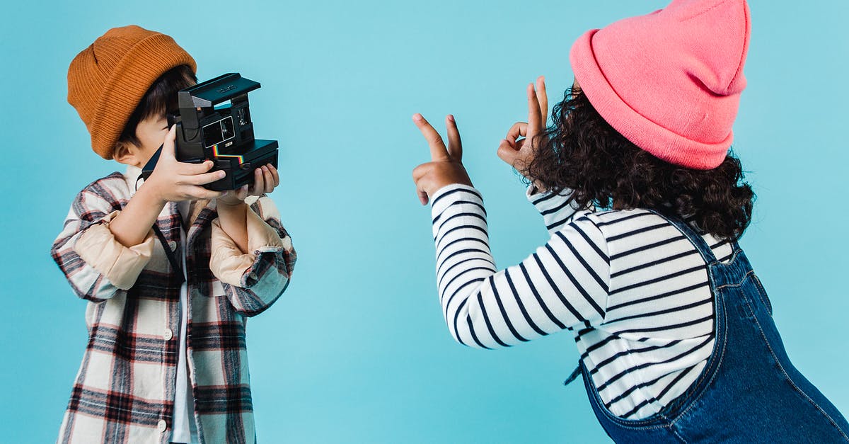 Best moment to put salt in spaghetti? - Positive diverse children taking photo on instant photo camera Best moment to put salt in spaghetti? - Positive diverse children taking photo on instant photo camera