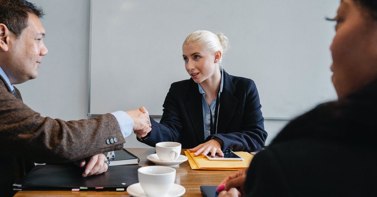 Best Office Coffee Solution [closed] - Group of diverse coworkers in formal suits shaking hands after successful business deal in office