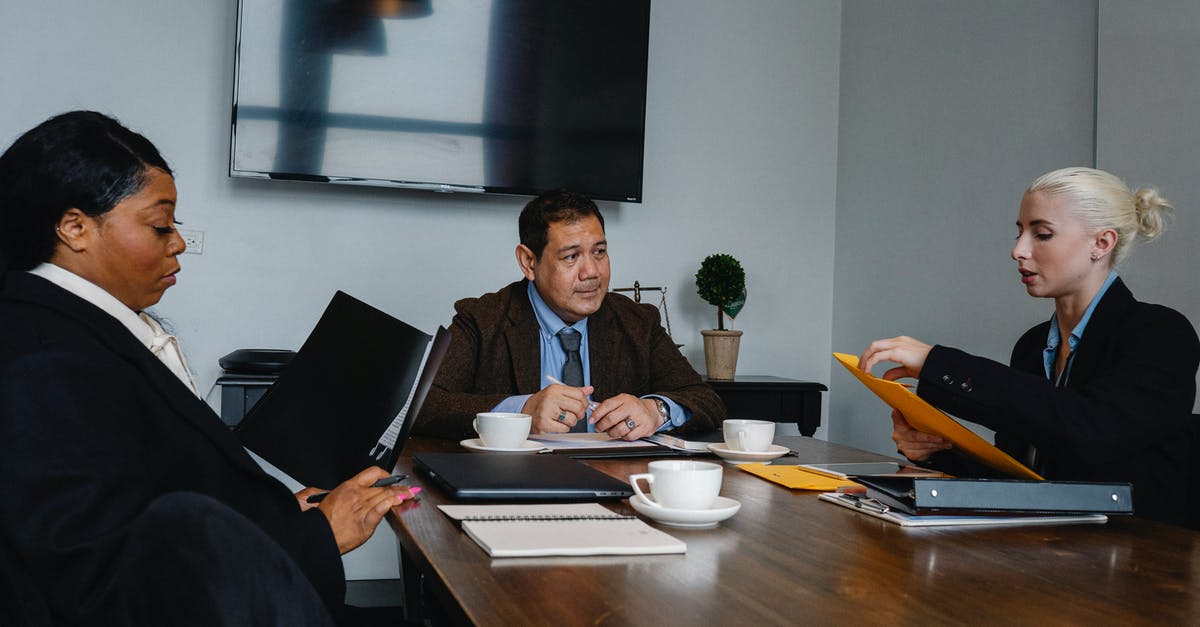 Best Office Coffee Solution [closed] - Group of multiethnic coworkers in formal wear sitting at table with documents and discussing strategy of project