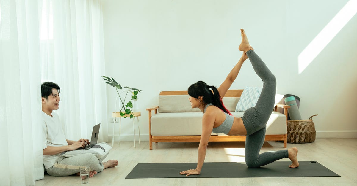 Best practices for using taps while avoiding cross contamination - Side view of young barefoot female in sportswear performing Tiger pose on mat during yoga session while Asian smiling male sitting crossed legged on floor and using netbook Best practices for using taps while avoiding cross contamination - Side view of young barefoot female in sportswear performing Tiger pose on mat during yoga session while Asian smiling male sitting crossed legged on floor and using netbook