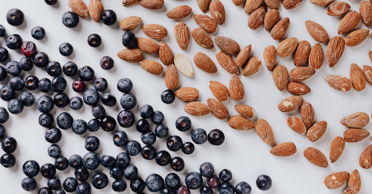 Best Texture for Vegan Ceviche - Raw almonds and fresh blueberries put on white surface