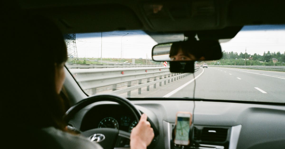 Best way to hold deep-fried foods? - Woman driving car on road in daytime
