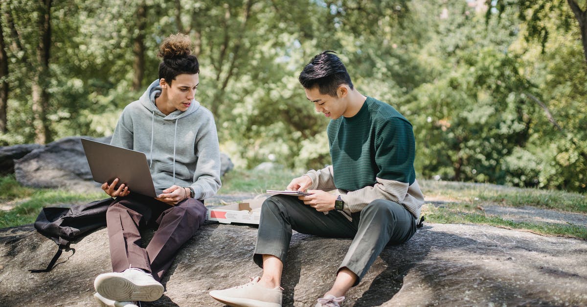 Best way to make pizza with limited options? - Full body young men in casual clothes spending time on ground with netbook and pizza while taking notes in notebook in summer sunny day with trees on background Best way to make pizza with limited options? - Full body young men in casual clothes spending time on ground with netbook and pizza while taking notes in notebook in summer sunny day with trees on background