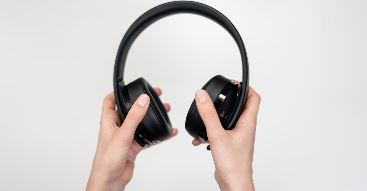 Black apple crumble! - Person Holding Black Cordless Headphones Black apple crumble! - Person Holding Black Cordless Headphones