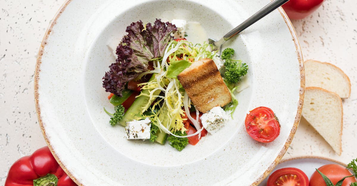 Black bit in olive oil - Sliced Vegetables on White Ceramic Plate Black bit in olive oil - Sliced Vegetables on White Ceramic Plate