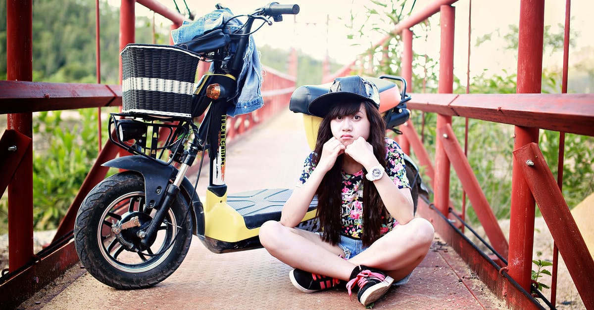 Black Diamond cheddar, wedge not wheel - Woman Sitting on Bridge With Motor Scooter Black Diamond cheddar, wedge not wheel - Woman Sitting on Bridge With Motor Scooter