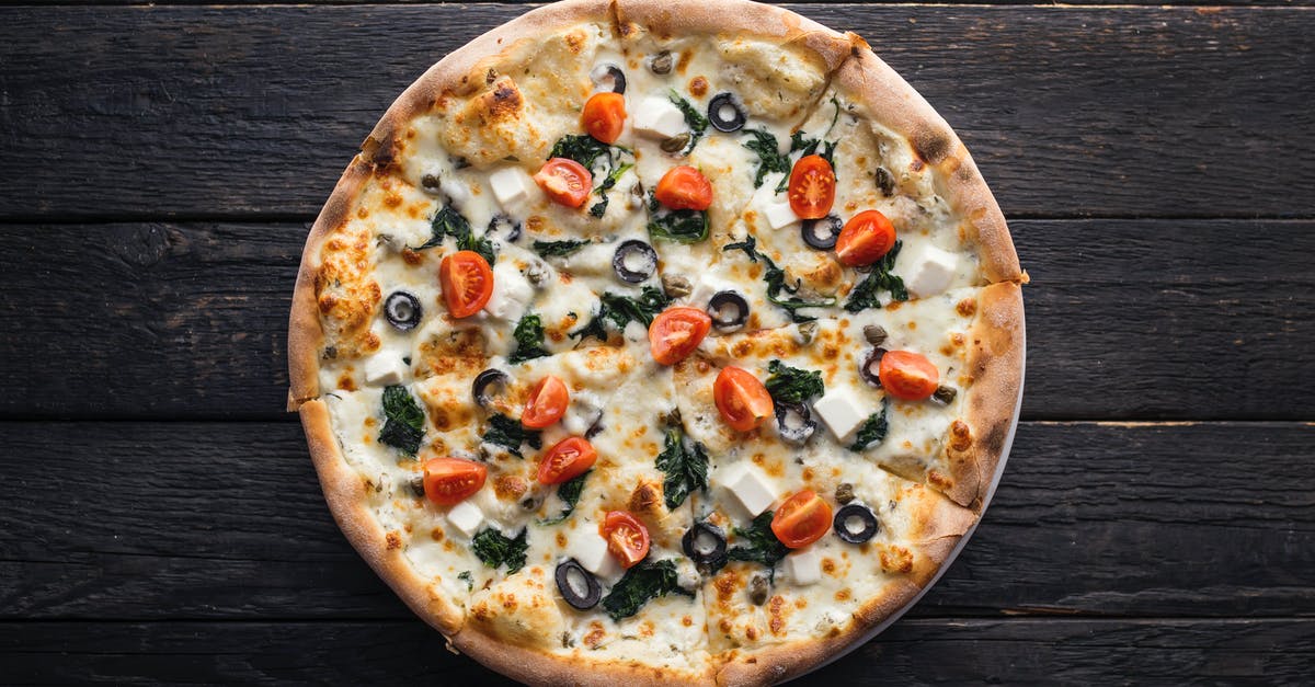 Black Mold On Cheese - Top view of yummy pizza with fresh tomato pieces on melted cheese on dark background Black Mold On Cheese - Top view of yummy pizza with fresh tomato pieces on melted cheese on dark background
