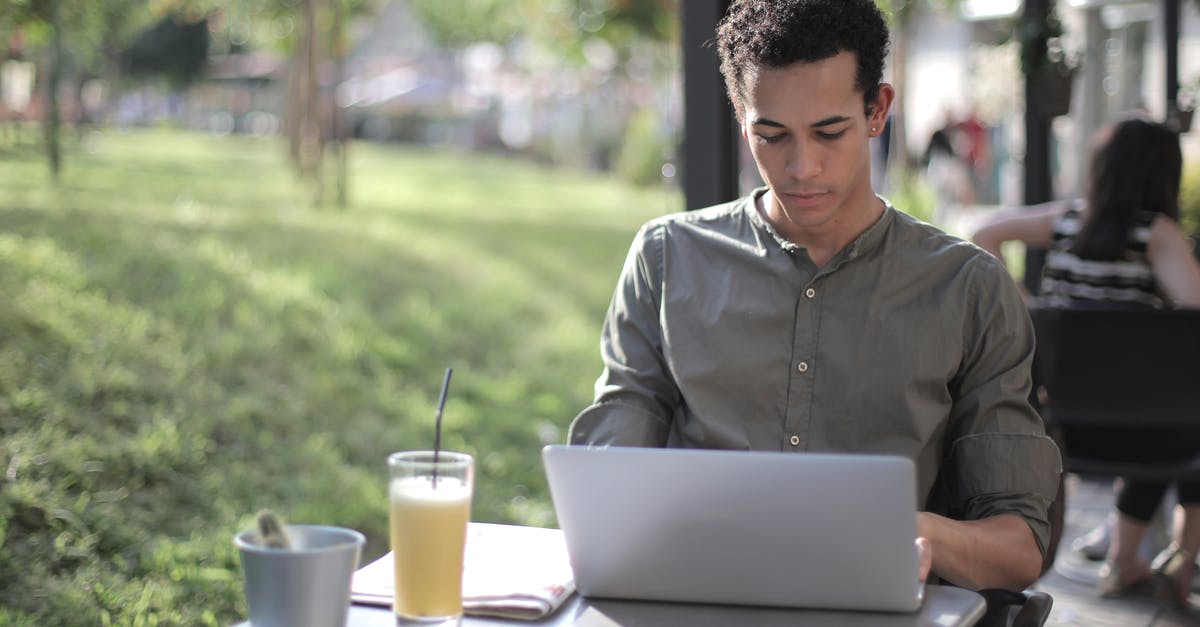 black residue in tea kettle - Focused black male freelancer using laptop in street cafe black residue in tea kettle - Focused black male freelancer using laptop in street cafe