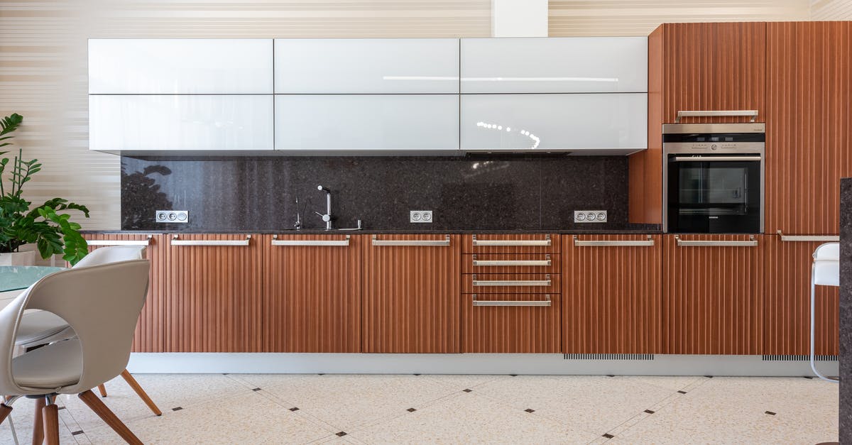 Black spots in the kitchen sink - Interior of contemporary kitchen in flat Black spots in the kitchen sink - Interior of contemporary kitchen in flat