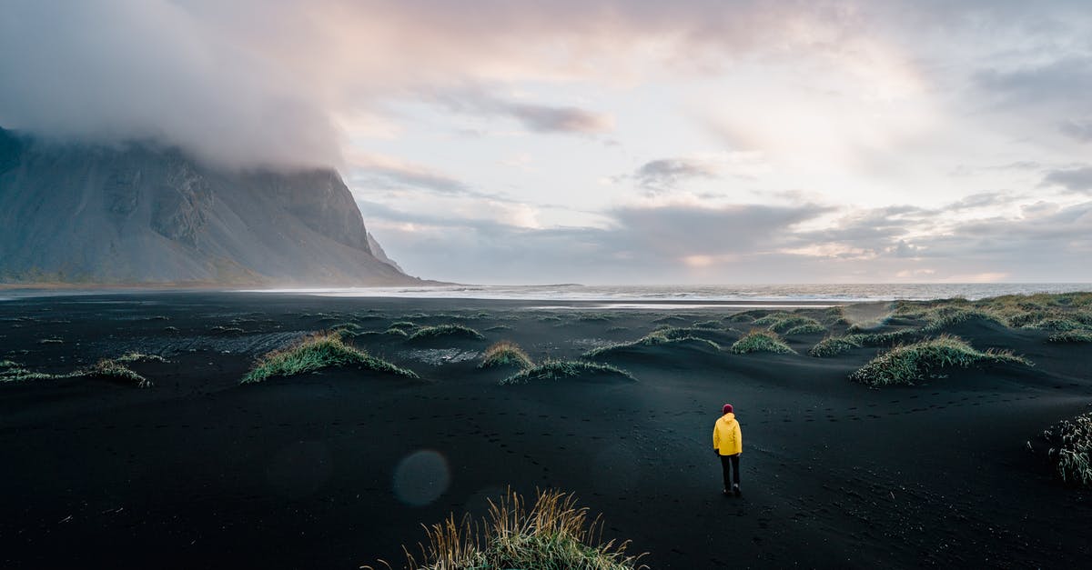 Black tea develops cloudy dregs; how to avoid? - Person in Yellow Jacket Standing on Green Grass Field Near Mountain Black tea develops cloudy dregs; how to avoid? - Person in Yellow Jacket Standing on Green Grass Field Near Mountain