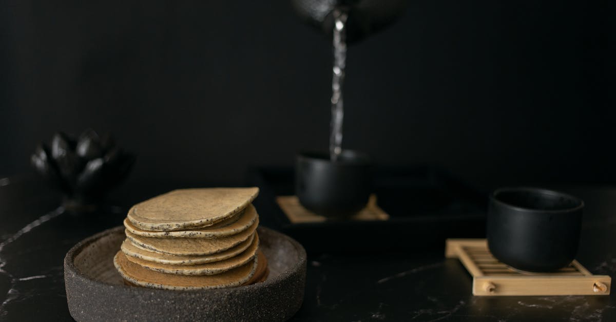 Black tea water: Does boiling water first make a difference? - Sweet pancakes near black cups Black tea water: Does boiling water first make a difference? - Sweet pancakes near black cups