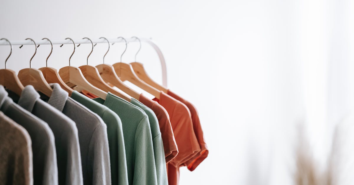 Bleach white shrimp, different species? - Interior of light apartment with different clothes on wooden hangers in wardrobe near white walls