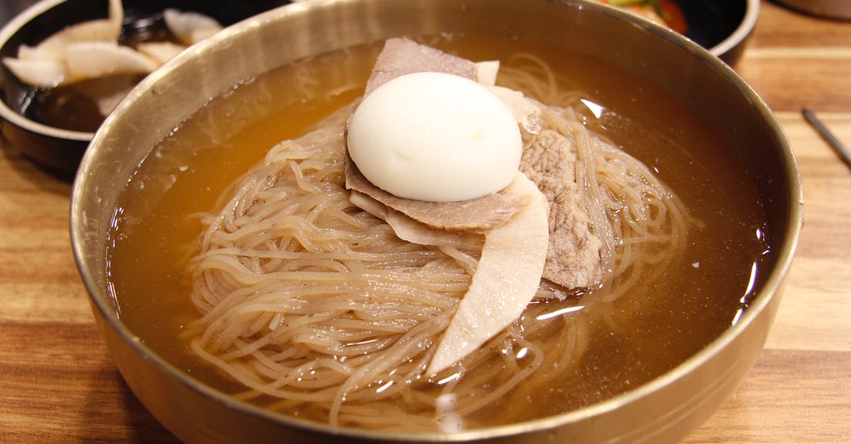 Boiling vs soaking rice noodles - Noodle Soup With Egg on Brown Wooden Bowl Boiling vs soaking rice noodles - Noodle Soup With Egg on Brown Wooden Bowl