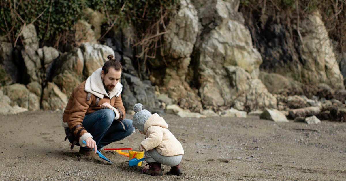 Bread Proving Time in Warm Climates - Father and kid playing with toys on sandy beach Bread Proving Time in Warm Climates - Father and kid playing with toys on sandy beach