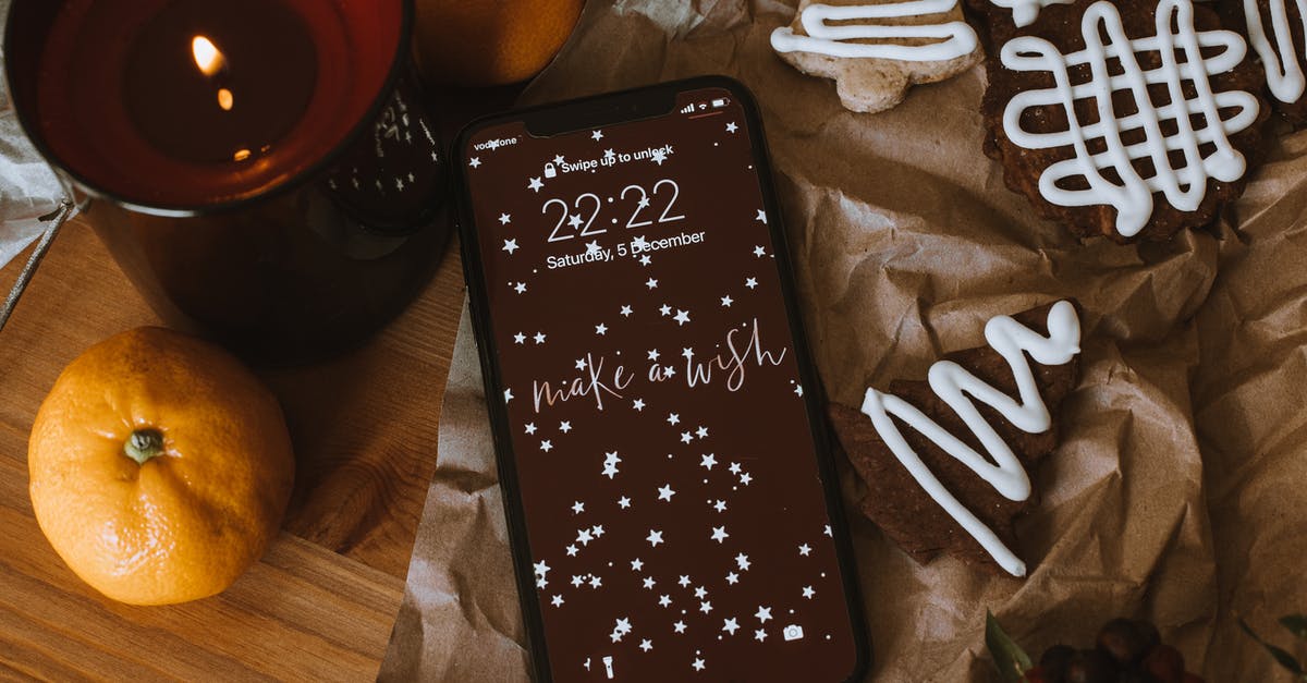 Breaking down fruit with sugar and water for cookies - Smartphone Near Lighted Candle and Mandarin Fruit on Wooden Surface Breaking down fruit with sugar and water for cookies - Smartphone Near Lighted Candle and Mandarin Fruit on Wooden Surface