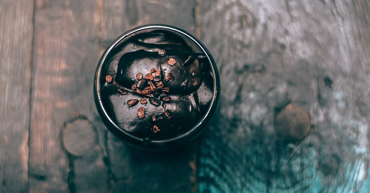 Brownie with chocolate mousse on top - Cup of yummy chocolate dessert served on wooden surface Brownie with chocolate mousse on top - Cup of yummy chocolate dessert served on wooden surface