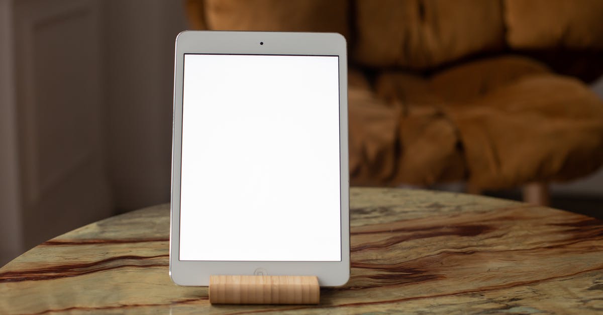 Butter Tablet Eruption - White Ipad on Brown Wooden Table Butter Tablet Eruption - White Ipad on Brown Wooden Table