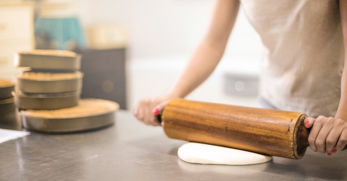 Cake flour weight [duplicate] - Person in White T-shirt Rolling a Pin in Dough