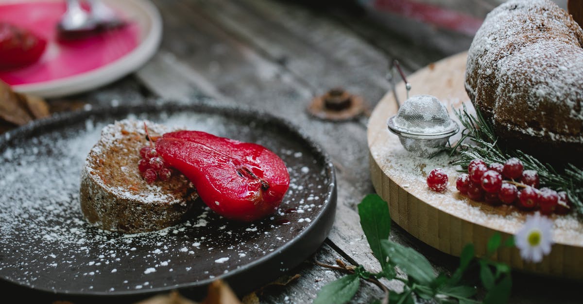 Cake flour weight [duplicate] - Appetizing composition of freshly baked sweet pie served on black plate with red marinated pear and decorated with sugar powder