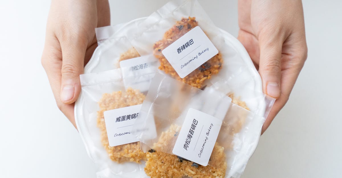 Calculating Nutrition Information for Commercial Food Labeling - Crop person holding plate with cookies in plastic bags Calculating Nutrition Information for Commercial Food Labeling - Crop person holding plate with cookies in plastic bags