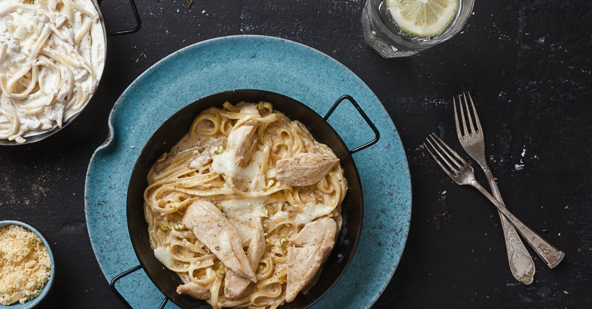 Calories in (cooked) pasta - Pasta Dish on Black Ceramic Bowl Near Forks and Glass With Water Calories in (cooked) pasta - Pasta Dish on Black Ceramic Bowl Near Forks and Glass With Water