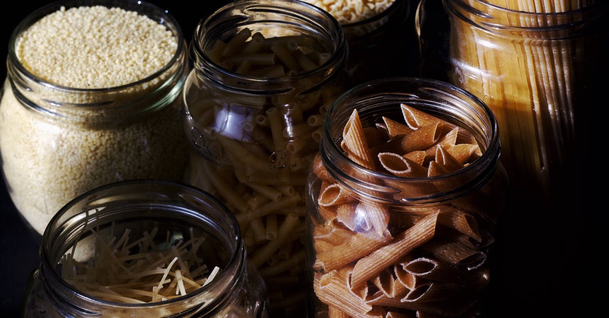 Calories in (cooked) pasta - Different types of pastas and cereals in glass jars on kitchen in sunlight Calories in (cooked) pasta - Different types of pastas and cereals in glass jars on kitchen in sunlight
