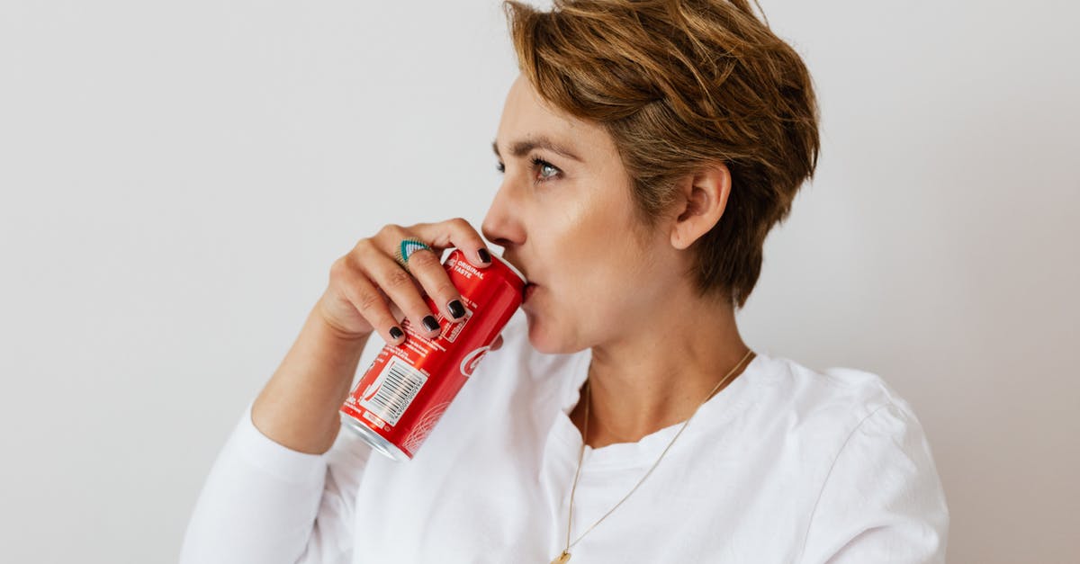 Can anyone identify this RED GINSENG CANDY? - Pensive female in white wear with gold necklace and ring on finger drinking cold coke from red can and looking away Can anyone identify this RED GINSENG CANDY? - Pensive female in white wear with gold necklace and ring on finger drinking cold coke from red can and looking away