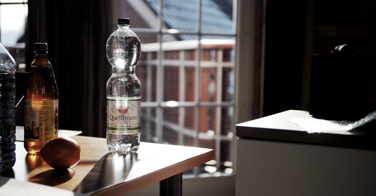 Can distilled water in gallon plastic bottles expire? - Glass Bottle on Brown Wooden Table