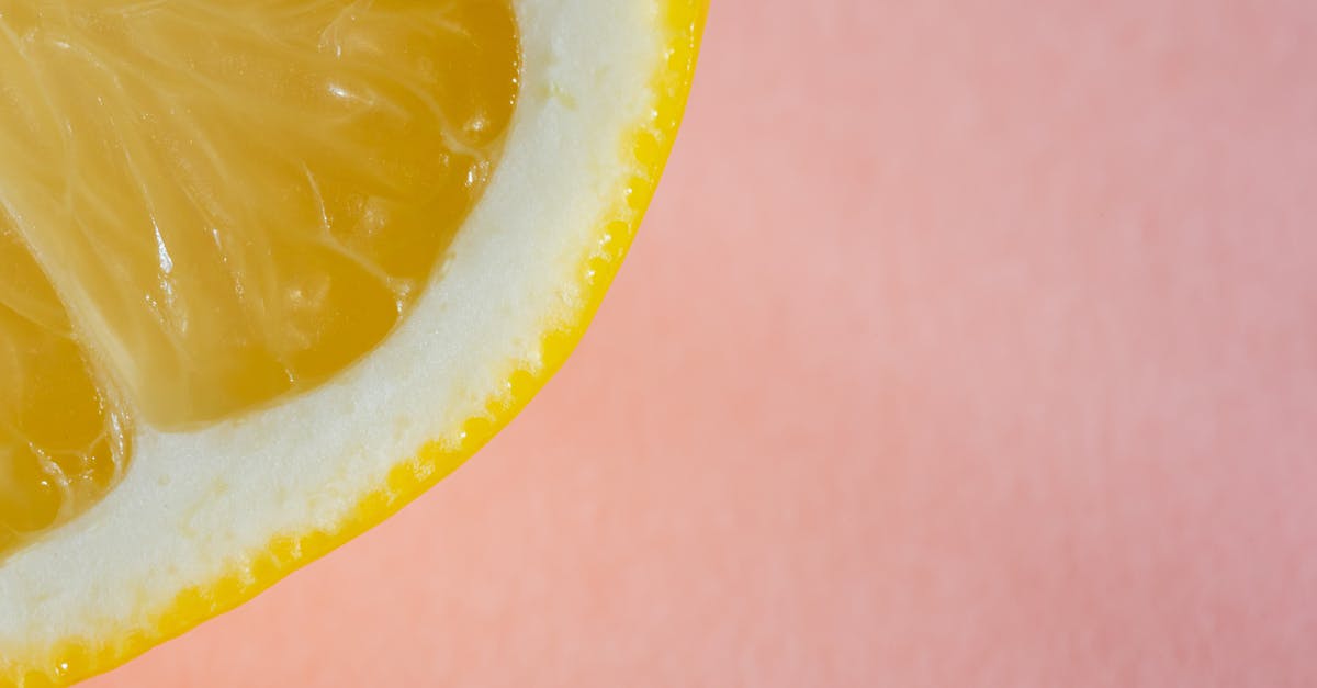 Can fresh citrus juice be reduced to concentrate flavor? - Quarter of lemon on pink background Can fresh citrus juice be reduced to concentrate flavor? - Quarter of lemon on pink background