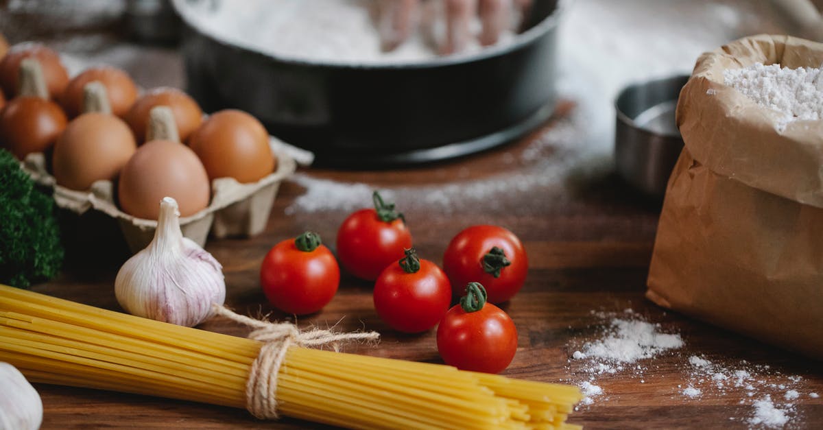 Can handmade pasta be more than just flour + eggs? - High angle of cherry tomatoes eggs garlic and spaghetti on table with crop chef kneading dough in baking dish Can handmade pasta be more than just flour + eggs? - High angle of cherry tomatoes eggs garlic and spaghetti on table with crop chef kneading dough in baking dish