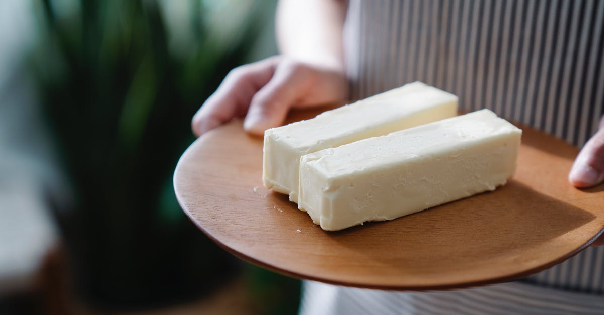 Can I always use butter instead of margarine when baking? - Close-Up Shot of a Person Holding a Wooden Plate with Sliced Butters Can I always use butter instead of margarine when baking? - Close-Up Shot of a Person Holding a Wooden Plate with Sliced Butters