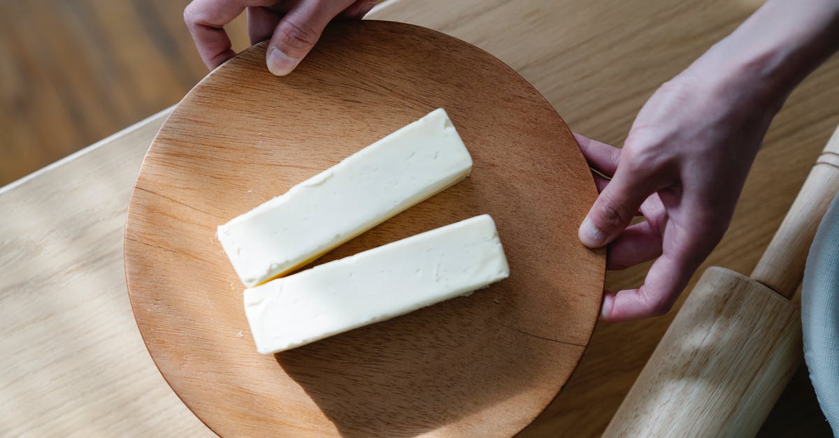 Can I always use butter instead of margarine when baking? - Close-Up Shot of a Person Holding a Wooden Plate with Sliced Butters Can I always use butter instead of margarine when baking? - Close-Up Shot of a Person Holding a Wooden Plate with Sliced Butters