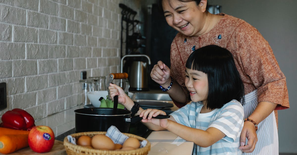 Can I double cook apple? When making, say, Apple Crumble? - Asian woman with granddaughter preparing food Can I double cook apple? When making, say, Apple Crumble? - Asian woman with granddaughter preparing food