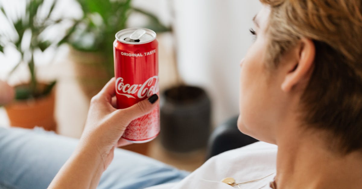 Can I freeze soup in a pot? - Crop anonymous woman resting at home with can of coke Can I freeze soup in a pot? - Crop anonymous woman resting at home with can of coke