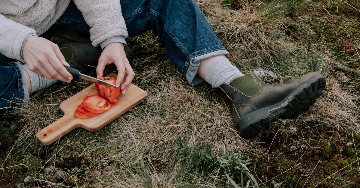 Can I just rinse the knife & cutting board, instead of washing it, after cutting washed vegetables? - Person in Blue Jeans Sitting on Grass 