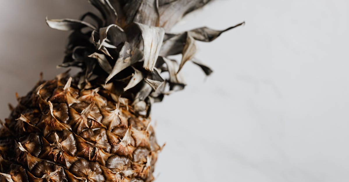 Can I know if lemons are safe to eat whole (peel and all)? - From above of fresh whole ripe pineapple placed on white marble texture pattern Can I know if lemons are safe to eat whole (peel and all)? - From above of fresh whole ripe pineapple placed on white marble texture pattern