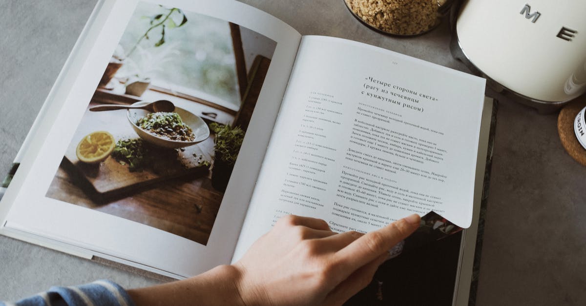 Can I learn to cook from a book? - Anonymous housewife paging cookbook in kitchen Can I learn to cook from a book? - Anonymous housewife paging cookbook in kitchen