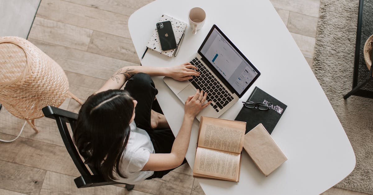 Can I learn to cook from a book? - Young lady typing on keyboard of laptop in living room Can I learn to cook from a book? - Young lady typing on keyboard of laptop in living room