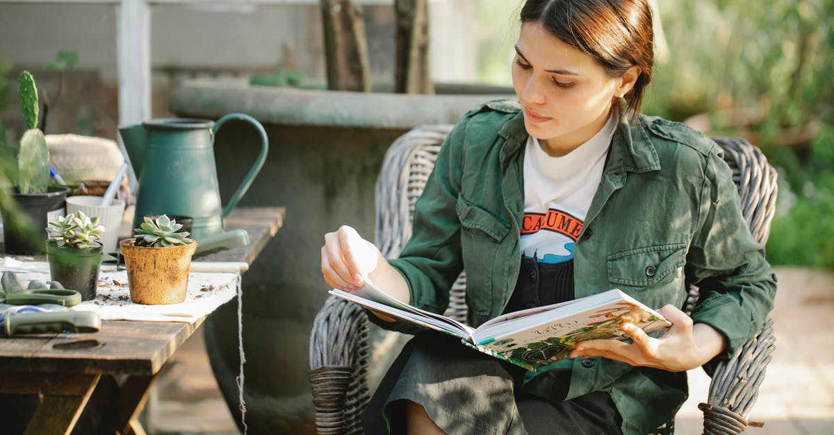 Can I learn to like wine? - Gardener reading book in armchair near plants in pots Can I learn to like wine? - Gardener reading book in armchair near plants in pots