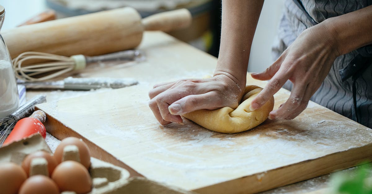 Can I make cornbread without flour? - Unrecognizable female cook pressing piece of dough on wooden board while cooking at table with whisk and rolling pin against blurred background Can I make cornbread without flour? - Unrecognizable female cook pressing piece of dough on wooden board while cooking at table with whisk and rolling pin against blurred background