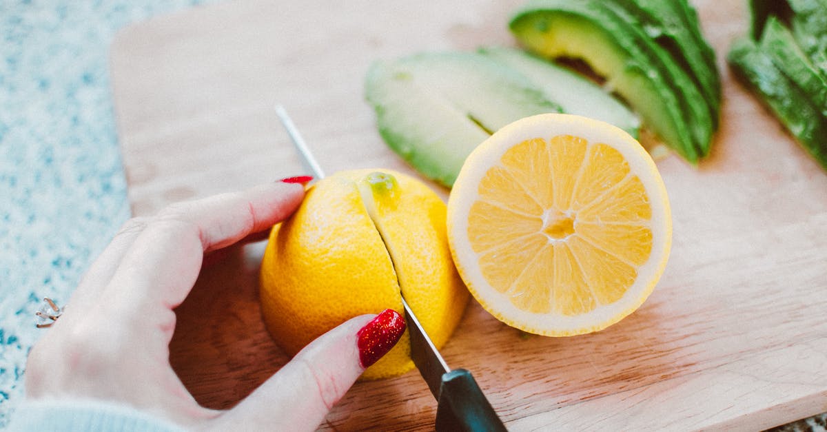 Can I make lemon curd more sour/tart after it's cooked? - Person Slicing Lemon on Wooden Chopping Board Can I make lemon curd more sour/tart after it's cooked? - Person Slicing Lemon on Wooden Chopping Board