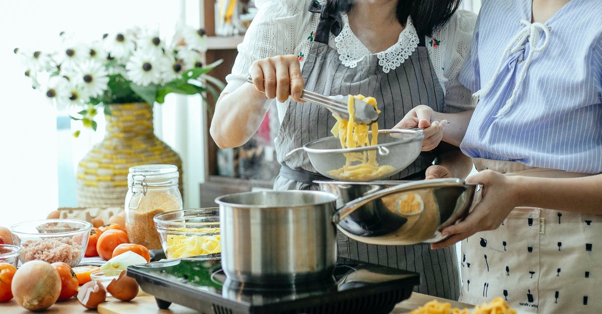 Can I put any kind of bowl into a steam/rice cooker? - Crop women cooking pasta in kitchen Can I put any kind of bowl into a steam/rice cooker? - Crop women cooking pasta in kitchen