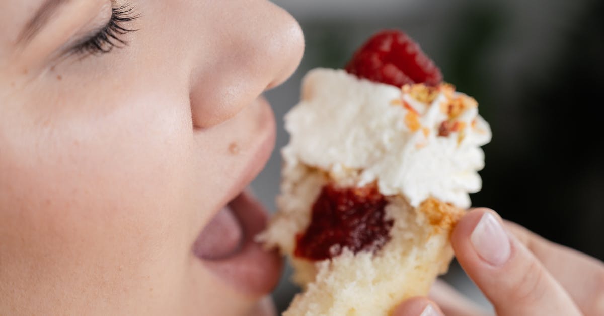 Can I refreeze defrosted crumb topping? - Crop unrecognizable female with closed eyes biting tasty sweet cupcake with with strawberry jam filing and decorated with whipped cream and berries Can I refreeze defrosted crumb topping? - Crop unrecognizable female with closed eyes biting tasty sweet cupcake with with strawberry jam filing and decorated with whipped cream and berries