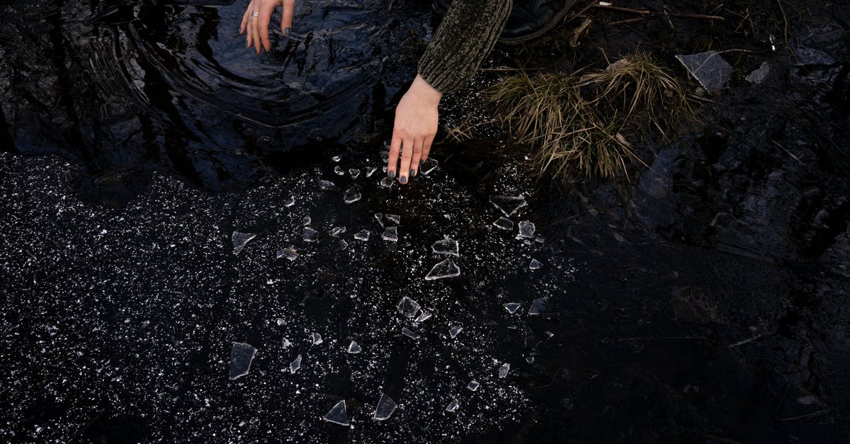 Can I save wet biscuits? - Crop woman picking up broken glass near lake in countryside Can I save wet biscuits? - Crop woman picking up broken glass near lake in countryside