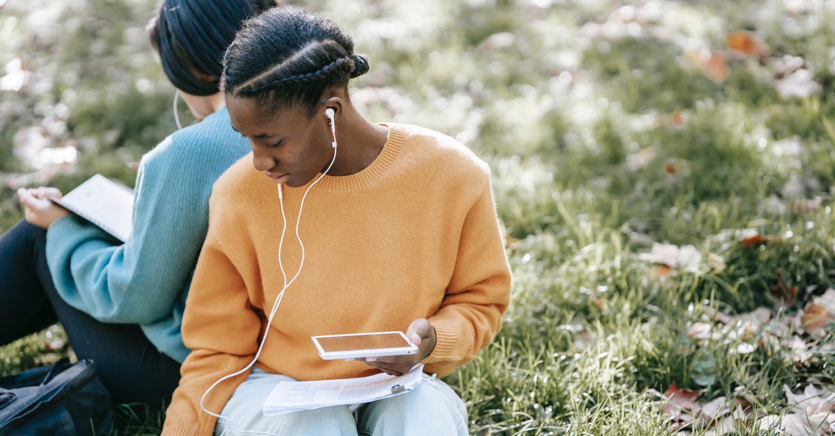 Can I season cast iron *without* using an oven? - Multiethnic women using tablet and reading in park Can I season cast iron *without* using an oven? - Multiethnic women using tablet and reading in park
