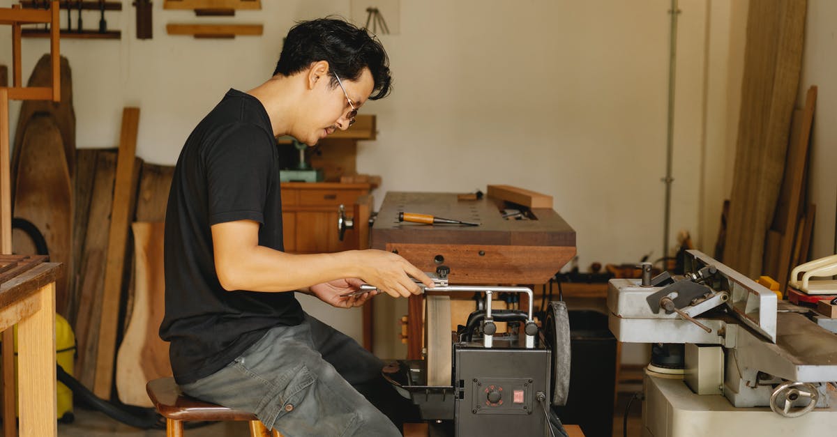 Can I sharpen a knife with sandpaper? - Side view of concentrated skilled ethnic male master sitting at electrical sharpening machine with sharp knife during work in joinery Can I sharpen a knife with sandpaper? - Side view of concentrated skilled ethnic male master sitting at electrical sharpening machine with sharp knife during work in joinery