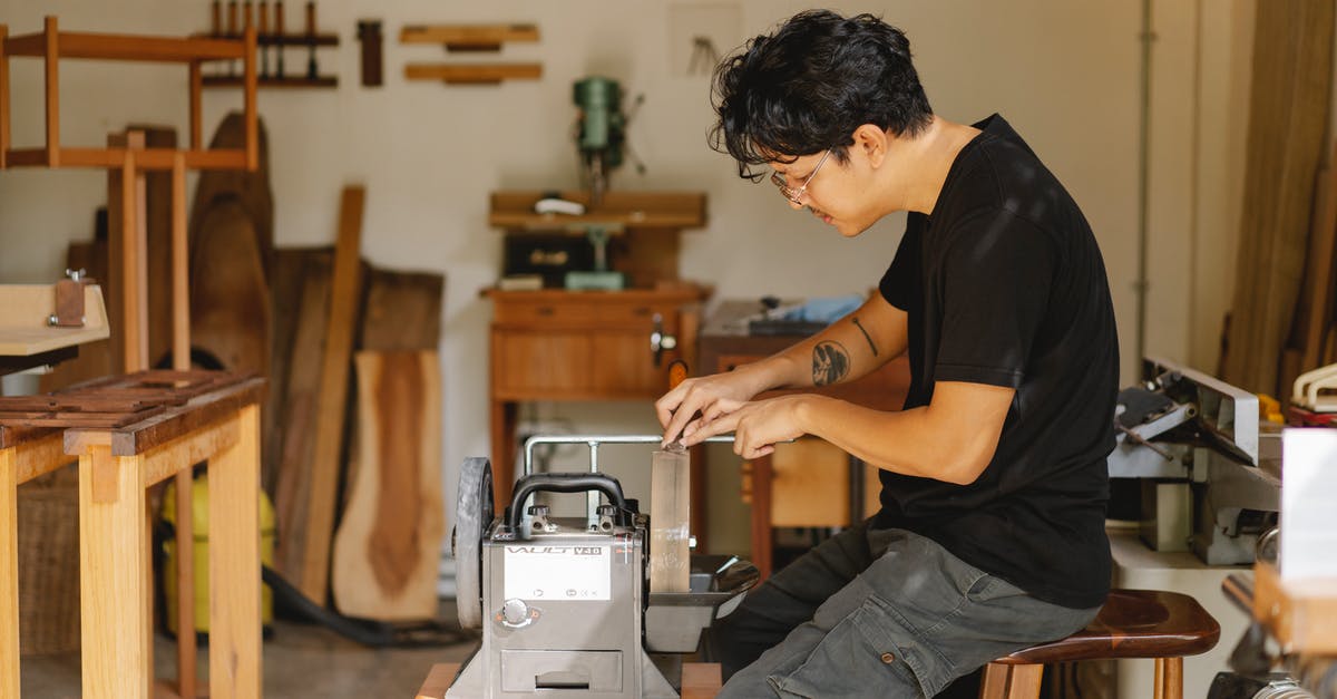 Can I sharpen a knife with sandpaper? - Professional ethnic artisan sitting at sharpening tool Can I sharpen a knife with sandpaper? - Professional ethnic artisan sitting at sharpening tool